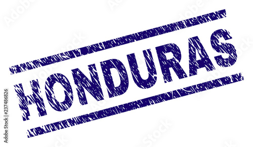 HONDURAS seal print with distress style. Blue vector rubber print of HONDURAS text with dirty texture. Text label is placed between parallel lines.