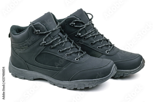 A pair of insulated black men's sports and travel boots isolated on white background.