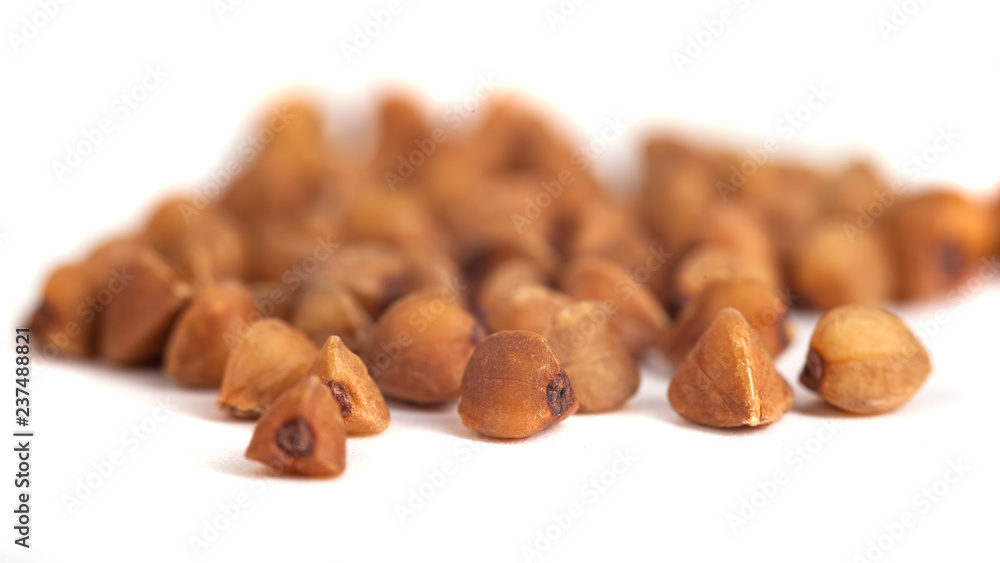 Obraz premium Buckwheat grain isolated on white background, healthy wood