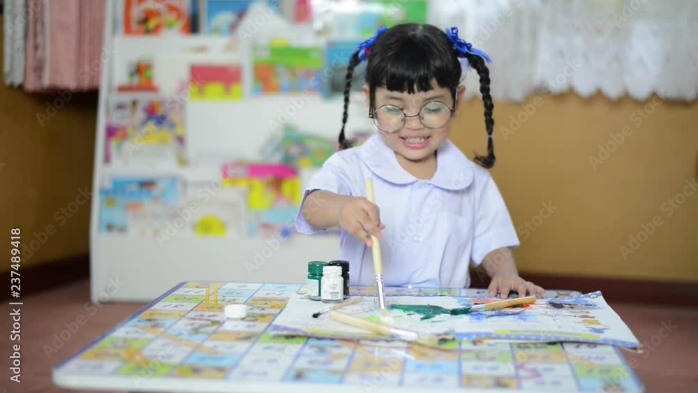 Drawing,Art,creative and schoolgirl concept. Asian little kid painting and drawing with brush on the paper at school. Drawing,Art,creative and schoolgirl concept. Asian little kid painting and drawing with brush on the paper at school.