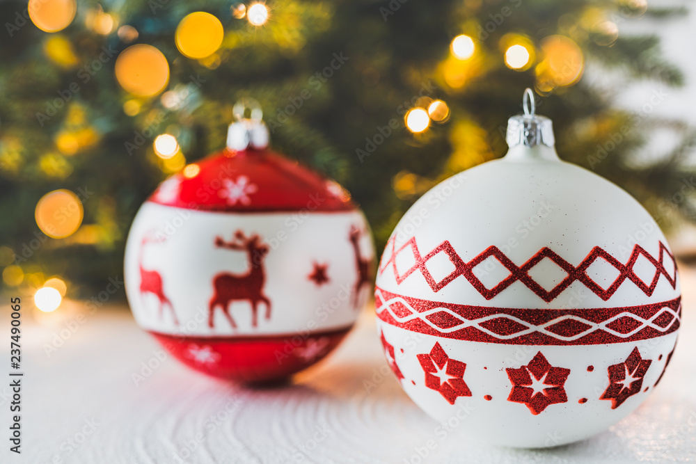 Red christmas balls on white background, Christmas tree, bokeh lights Red christmas balls on white background, Christmas tree, bokeh lights