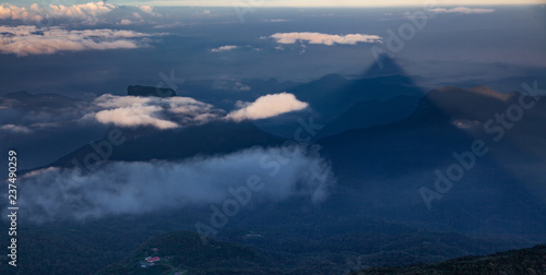 shadow of the conical mountain Adam s Peak or Sri Pada at sunrise - sacred buddhist place. Sri Lanka