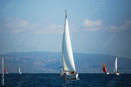Sailing boats participate in sail yacht regatta in Aegean Sea, Greece.