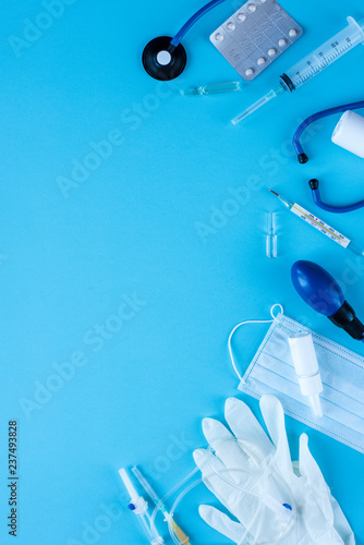 Different medical equipment on blue background. The view from the top.