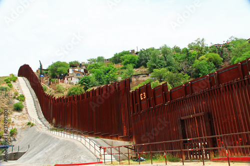 Border Fence beside a street in downtown Nogales, Arizona separating the United States from Mexico. photo