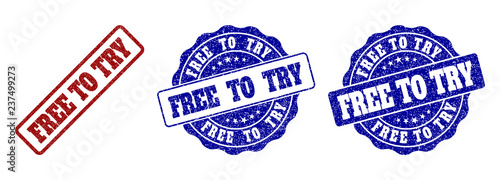 FREE TO TRY scratched stamp seals in red and blue colors. Vector FREE TO TRY labels with scratced surface. Graphic elements are rounded rectangles, rosettes, circles and text captions.