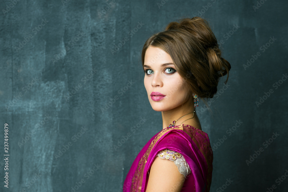 Beautiful fashion Indian woman portrait with oriental accessories earrings