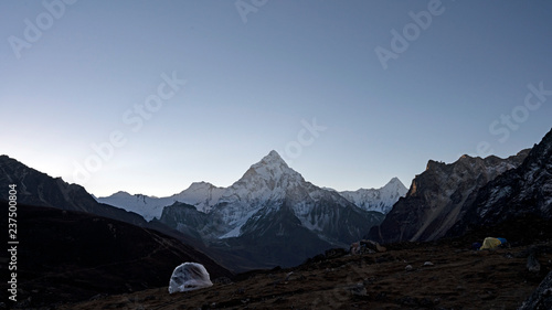 A heap of Yak Dung is covered overnight to keep it dry. Yak Dung is critical in heating and fuel for cooking in Nepal. Ama Dablam is one the most iconic peaks of Nepal.