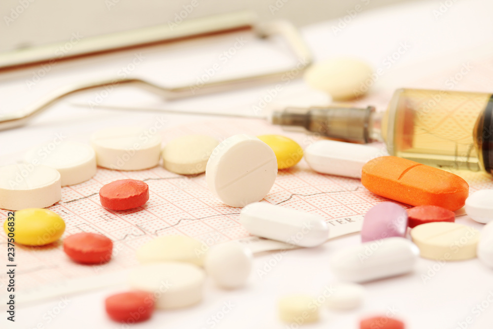 Medication pills and a sirynge as a medical healthcare concept Medication pills and a sirynge as a medical healthcare concept