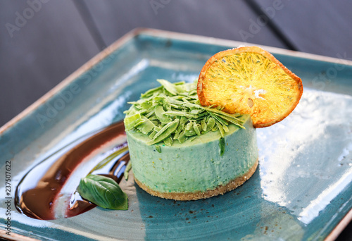 Delicious mint cheesecake with candied fruit and jam on plate