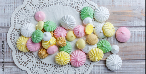 Colorful meringue cookies on napkin, natural light selective focus