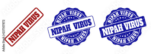 NIPAH VIRUS scratched stamp seals in red and blue colors. Vector NIPAH VIRUS labels with dirty surface. Graphic elements are rounded rectangles, rosettes, circles and text labels.