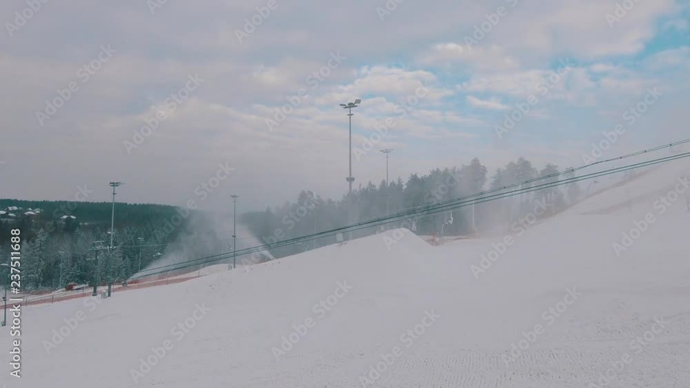 Winter, ski resort, snow cannons produce snow for the slope. Winter, ski resort, snow cannons produce snow for the slope.