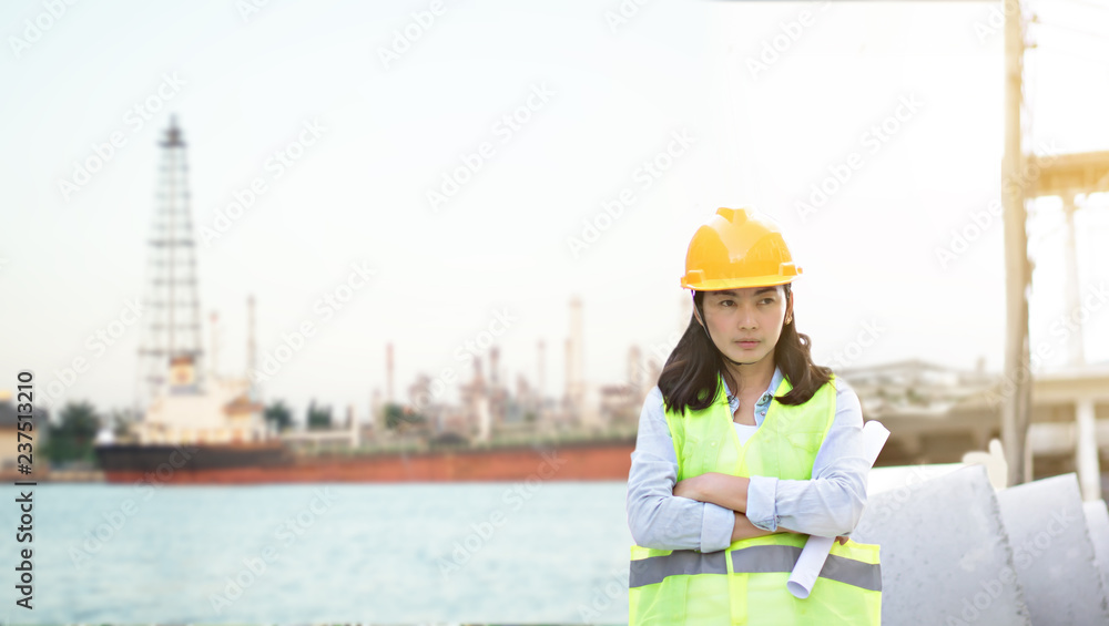Engineering wearing yellow helmet and working at construction site about transportation of international logistics background Engineering wearing yellow helmet and working at construction site about transportation of international logistics background