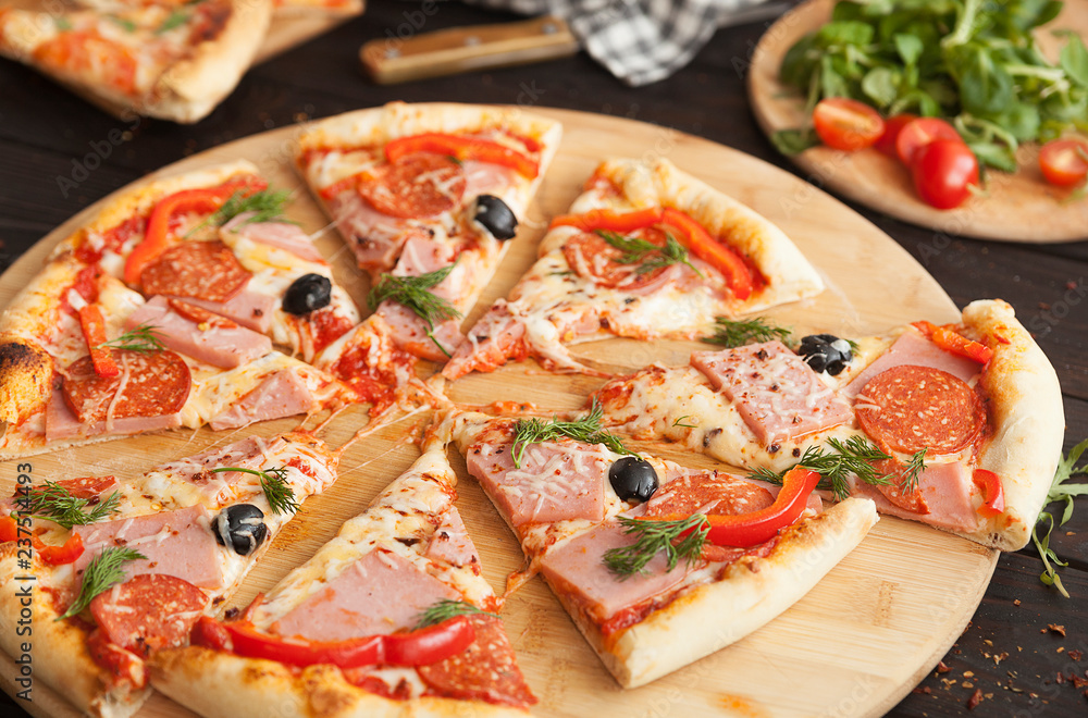 pizza, fresh pizza with mozzarella, tomatoes, ham and cheese. Italian pizzeria. Fresh pizza on the kitchen table
pizza, fresh pizza with mozzarella, tomatoes, ham and cheese. Italian pizzeria. Fresh pizza on the kitchen table