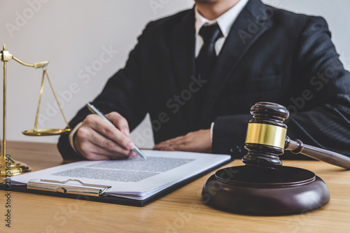 Judge gavel with Justice lawyers, counselor in suit or lawyer working on a documents at law firm in office. Legal law, advice and justice concept