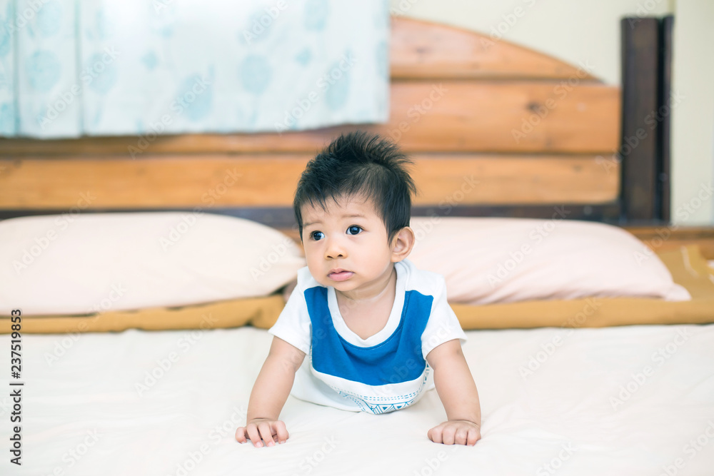 Portrait of a crawling baby on the bed in her room Portrait of a crawling baby on the bed in her room