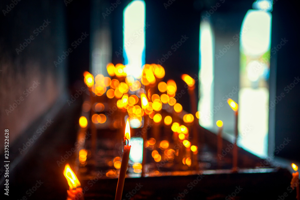 prayer burning candles inside the church 