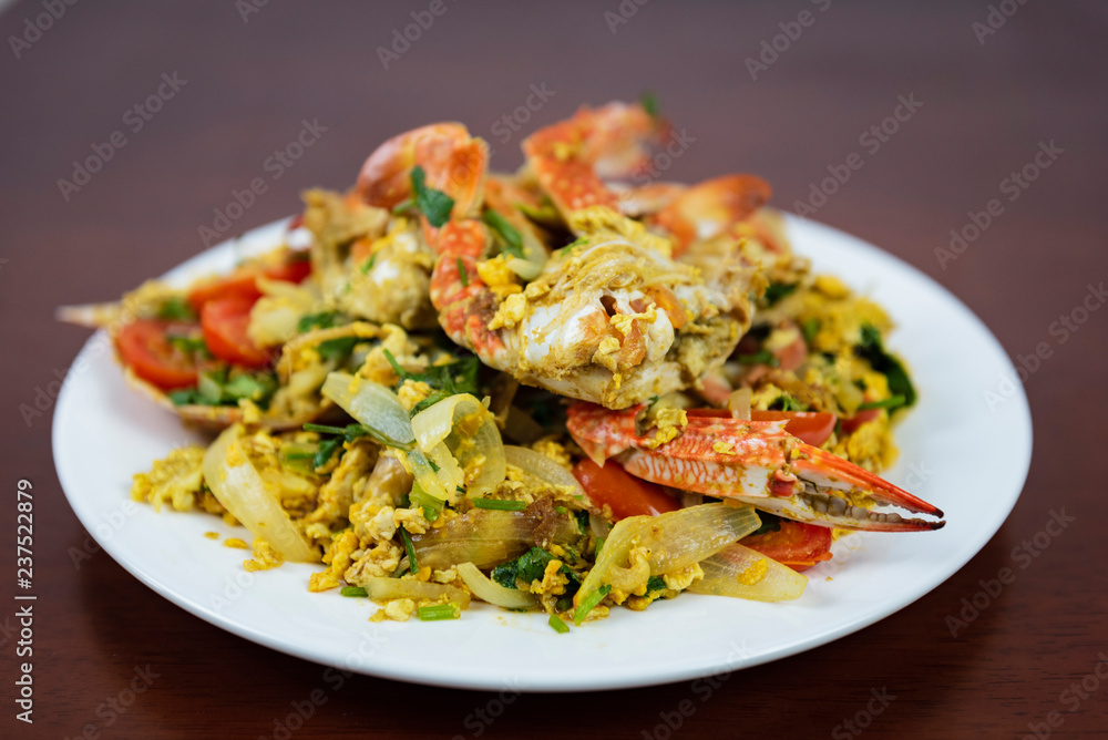 Stir Fried Crab with Curry Powder, Closeup, Thai Food on a wooden background Stir Fried Crab with Curry Powder, Closeup, Thai Food on a wooden background