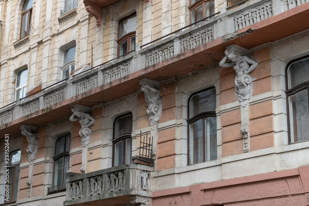 The facade of the old multistory building. Many windows and balconies supported by atlants and caryatids The facade of the old multistory building. Many windows and balconies supported by atlants and caryatids