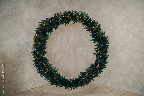 A large Christmas wreath on the wall.