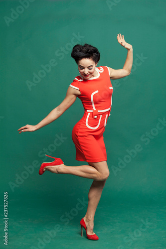 pin-up girl in red dress lifted her leg