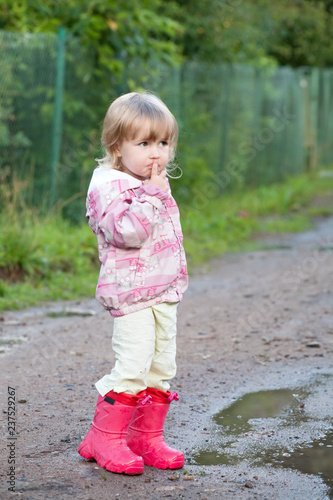 cute toddler girl in gumboots