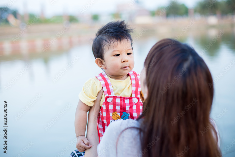 Beautiful Mother And Baby outdoors. Nature. Beauty Mum and her Child playing in Park together. Beautiful Mother And Baby outdoors. Nature. Beauty Mum and her Child playing in Park together.