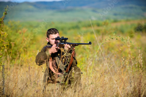 Man hunter aiming rifle nature background. Guy hunting nature environment. Hunting weapon gun or rifle. Hunting target. Masculine hobby activity. Experience and practice lends success hunting
