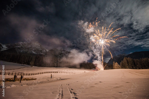Canvas Print Firework for new year's eve in the mountains with some people whatching the expl