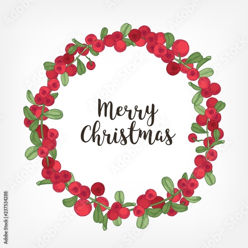 Merry Christmas lettering inside holiday wreath or circular garland made of lingonberries