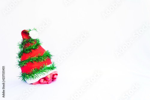 Christmas background with red hat, colorful ribbon tree decoration