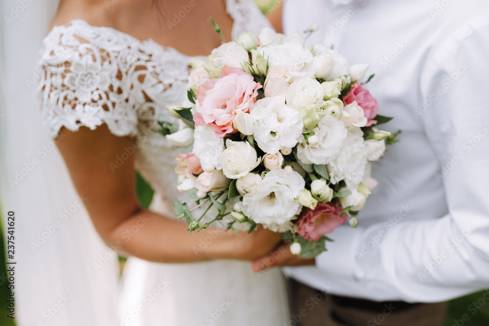 bride holding bouquet of flowers in rustic style, wedding bouquet Groom hugs bride bride holding bouquet of flowers in rustic style, wedding bouquet Groom hugs bride
