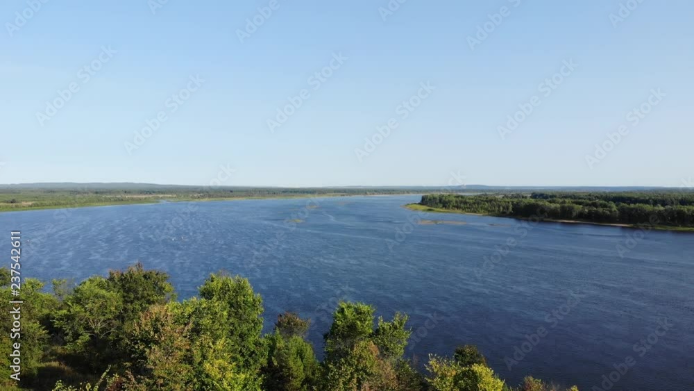 View from above. Flying over the river and trees in summer. Shooting from the quadcopter. 4K View from above. Flying over the river and trees in summer. Shooting from the quadcopter. 4K