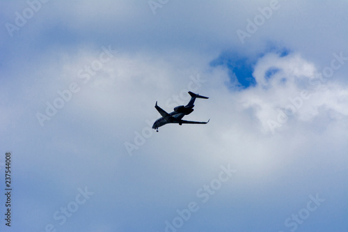 A large passenger airliner is a plane with a big wingspan high in the sky. Transport tourists for exotic holidays against the blue sky and white clouds