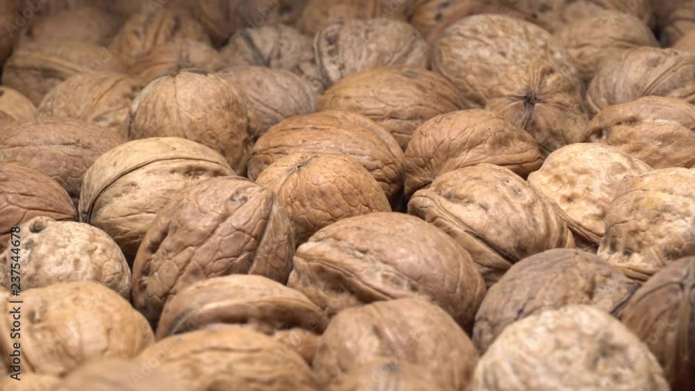 Walnuts in nutshell. Rotation. Closeup. Selective focus. Healthy food concept. Walnuts in nutshell. Rotation. Closeup. Selective focus. Healthy food concept.