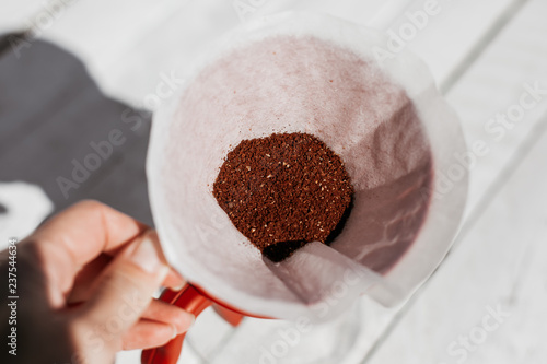 Delicious freshly ground morning coffee powder in the coffee filter