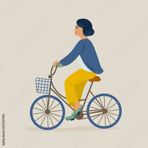 Young smiling woman or girl dressed in casual clothes riding bicycle. Female ...