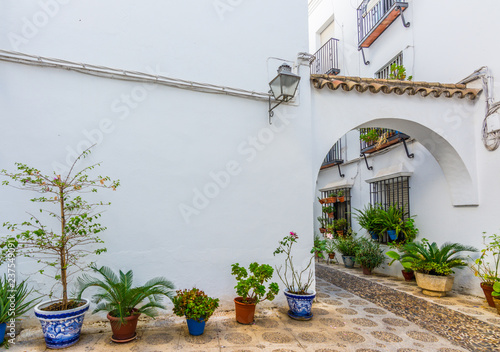 Picturesque white street of Cordoba. Typical andalusian white houses in Southern Spain.