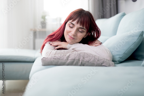 Peaceful woman resting and sleeping on sofa at home during day © leszekglasner