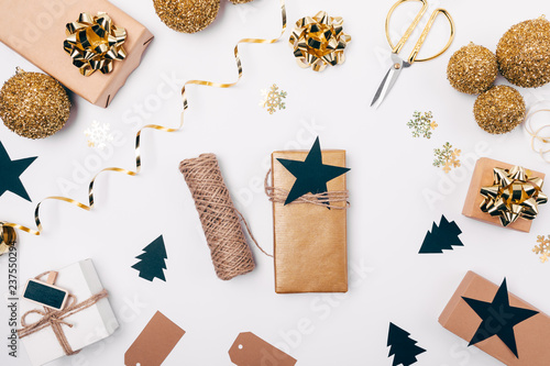 Fototapeta Naklejka Na Ścianę i Meble -  Gift box with twine and star among festive flat lay frame