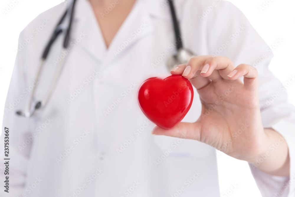 Medicine doctor holding red heart shape in hands on hospital background, medical concept Medicine doctor holding red heart shape in hands on hospital background, medical concept