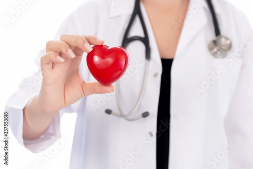 Medicine doctor holding red heart shape in hands on hospital background, medical concept