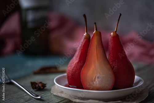 Boiled pears in spices and wine. Festive food. Blurred background.