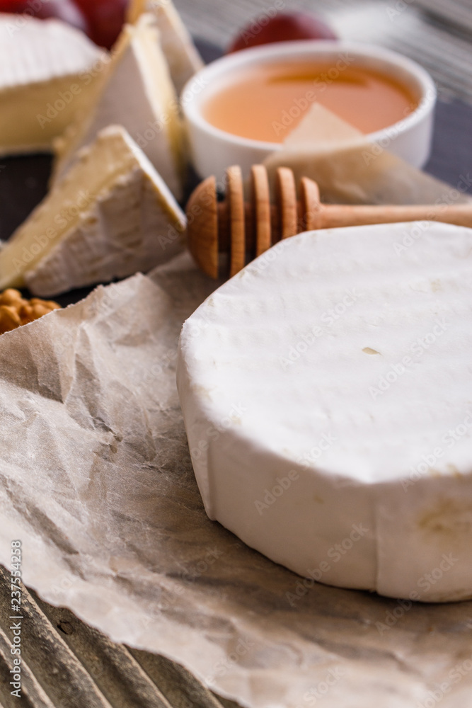 delicious creamy camembert cheese on a wooden rustic background
