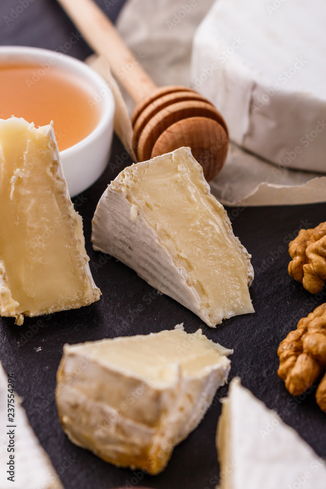 delicious creamy camembert cheese on a wooden rustic background delicious creamy camembert cheese on a wooden rustic background