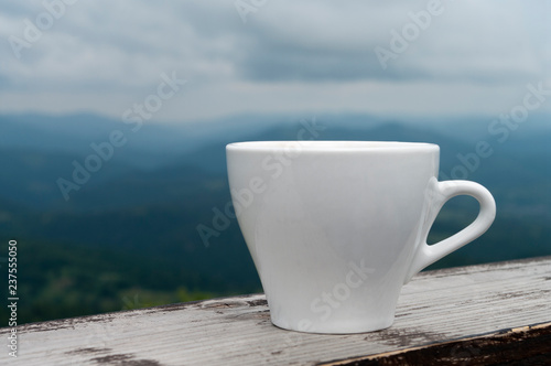 white cup in the mountains