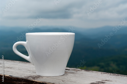 white cup in the mountains