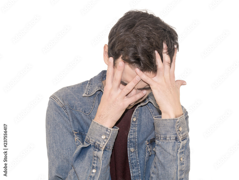 Portrait of despair young man closed face by two hands. Isolated on a white background. Portrait of despair young man closed face by two hands. Isolated on a white background.