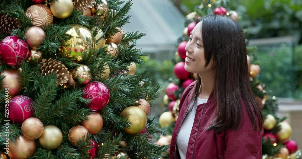 Woman look at the Christmas tree Woman look at the Christmas tree
